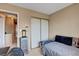 Bedroom featuring neutral walls, a storage closet, and a bed with blue accents at 5731 Fonchester Ct, Las Vegas, NV 89110