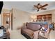 Bedroom featuring a ceiling fan, neutral colored walls, and a comfortable seating area at 5731 Fonchester Ct, Las Vegas, NV 89110
