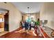 Dining room boasts a modern chandelier, seating for four, and wood floors at 5731 Fonchester Ct, Las Vegas, NV 89110