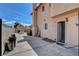 Rear view of the home, showcasing a yard, patio, and secure access to the residence at 5731 Fonchester Ct, Las Vegas, NV 89110