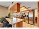 Cozy kitchen featuring stainless steel appliances, wood cabinets and breakfast bar at 5731 Fonchester Ct, Las Vegas, NV 89110