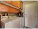 Functional laundry room with washer, dryer, and storage cabinets at 5731 Fonchester Ct, Las Vegas, NV 89110