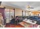 Bright living room featuring hardwood floors, large windows, and comfortable seating at 5731 Fonchester Ct, Las Vegas, NV 89110