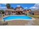 This property features a beautiful blue in-ground pool with well-kept gravel and a cozy covered patio at 5731 Fonchester Ct, Las Vegas, NV 89110