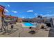 Wide shot of the backyard pool and patio area, with lush landscaping and ample seating space at 5731 Fonchester Ct, Las Vegas, NV 89110