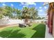 Backyard features a fire pit, desert landscaping and artificial turf at 5769 Larkdale St, Las Vegas, NV 89120