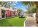 Landscaped backyard featuring an outdoor seating area and artificial turf at 5769 Larkdale St, Las Vegas, NV 89120