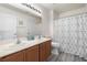 Bathroom featuring double sinks, a shower-tub combo, and modern fixtures at 5769 Larkdale St, Las Vegas, NV 89120