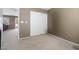 Neutral bedroom features a closet with white sliding doors and neutral carpet at 5769 Larkdale St, Las Vegas, NV 89120