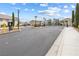 Gated community entrance featuring secure access, landscaping, and decorative lighting for a welcoming atmosphere at 5769 Larkdale St, Las Vegas, NV 89120