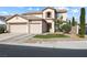 Inviting two-story home with manicured lawn and three-car garage, offering great curb appeal at 5769 Larkdale St, Las Vegas, NV 89120