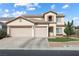 Charming two-story home boasts a three-car garage, manicured lawn, and inviting curb appeal at 5769 Larkdale St, Las Vegas, NV 89120