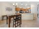 Kitchen boasts stainless steel appliances, warm wood cabinets, and a marble topped island with seating at 5769 Larkdale St, Las Vegas, NV 89120