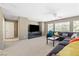 Open concept living room with a large sofa and ceiling fan at 5769 Larkdale St, Las Vegas, NV 89120