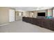 Open floor plan living area with a long sofa and stair railing at 5769 Larkdale St, Las Vegas, NV 89120