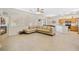 Open-concept living room with fireplace and plush sectional sofa open to dining area at 5769 Larkdale St, Las Vegas, NV 89120