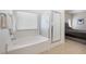 Bright main bathroom featuring tub, shower, and modern fixtures at 5769 Larkdale St, Las Vegas, NV 89120
