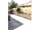 Long concrete patio area with mature landscaping and a privacy wall on the property line at 6030 Halehaven Dr, Las Vegas, NV 89110