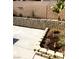 Backyard featuring a concrete patio, retaining wall with rock garden, and desert landscaping at 6030 Halehaven Dr, Las Vegas, NV 89110