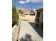 Spacious backyard featuring a concrete patio, a retaining wall, and desert landscaping at 6030 Halehaven Dr, Las Vegas, NV 89110