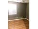 This bedroom features neutral colored walls, wood floors, and a ceiling fan for comfort at 6030 Halehaven Dr, Las Vegas, NV 89110