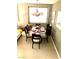Elegant dining area with a glass-top table set for a meal, complemented by stylish décor at 6030 Halehaven Dr, Las Vegas, NV 89110