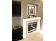 Cozy fireplace with white mantel and decorative art for a warm and inviting ambiance at 6030 Halehaven Dr, Las Vegas, NV 89110