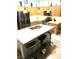 Well-equipped kitchen features stainless steel appliances, island with bar seating and plenty of counterspace at 6030 Halehaven Dr, Las Vegas, NV 89110