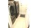 The laundry room is equipped with a gray, modern washer and dryer set at 6030 Halehaven Dr, Las Vegas, NV 89110