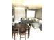 Living and dining area featuring comfortable seating, a ceiling fan, and ample natural light at 6030 Halehaven Dr, Las Vegas, NV 89110