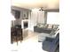 Comfortable living room area with a fireplace and neutral toned furniture at 6030 Halehaven Dr, Las Vegas, NV 89110