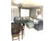 Inviting living room with a sectional couch, ceiling fan, and plenty of natural light at 6030 Halehaven Dr, Las Vegas, NV 89110