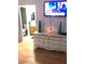 Living room showcasing a white dresser with an entrance to a bathroom at 6030 Halehaven Dr, Las Vegas, NV 89110