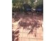 Relaxing patio featuring dark wicker seating and a small table, shaded by trees at 6030 Halehaven Dr, Las Vegas, NV 89110