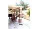 Covered patio with ceiling fans and outdoor dining set, perfect for entertaining at 6030 Halehaven Dr, Las Vegas, NV 89110