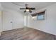 Sunlit room with wood-look floors, window, and ceiling fan at 6205 Parsifal Pl, Las Vegas, NV 89107