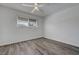 Bright bedroom featuring wood-look flooring, a ceiling fan, and a window at 6205 Parsifal Pl, Las Vegas, NV 89107