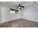 A bright room with wood-look flooring, a window, and a ceiling fan at 6205 Parsifal Pl, Las Vegas, NV 89107