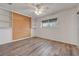Bright bedroom with built in shelving, laminate wood flooring and ceiling fan at 6205 Parsifal Pl, Las Vegas, NV 89107