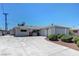 Single story home featuring a spacious driveway with desert landscaping at 6205 Parsifal Pl, Las Vegas, NV 89107