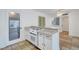 Bright kitchen with white cabinets, tile floors and modern appliances at 6205 Parsifal Pl, Las Vegas, NV 89107