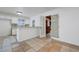 Open kitchen and dining area with tiled floors, white cabinets, and stainless steel appliances at 6205 Parsifal Pl, Las Vegas, NV 89107