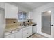 Bright kitchen with stainless steel appliances, double sink, tile backsplash, and access to the pantry at 6205 Parsifal Pl, Las Vegas, NV 89107
