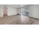 The living room features light, bright walls and wood laminate flooring with sliding door to the back yard at 6205 Parsifal Pl, Las Vegas, NV 89107