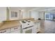 Open-concept kitchen and living area with sleek floors and backyard access at 6205 Parsifal Pl, Las Vegas, NV 89107