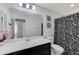 Modern bathroom featuring sleek black and white Paris-themed shower curtain and vanity with a large mirror at 6276 Point Isabel Way, Las Vegas, NV 89122