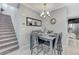 Inviting dining area with tiled floors, gray walls, modern chandelier and carpeted stairs at 6276 Point Isabel Way, Las Vegas, NV 89122