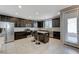 Modern kitchen featuring dark cabinetry, stainless steel appliances, and a granite island at 6276 Point Isabel Way, Las Vegas, NV 89122