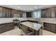 Modern kitchen featuring dark cabinetry, stainless steel appliances, and a granite island at 6276 Point Isabel Way, Las Vegas, NV 89122