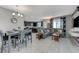 Open concept dining and living area with tiled floors, gray sofa, and contemporary decor at 6276 Point Isabel Way, Las Vegas, NV 89122